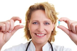 doctor holding a pill in each hand