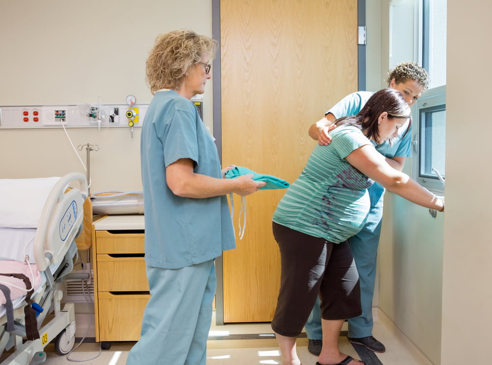 midwives and mother in delivery room