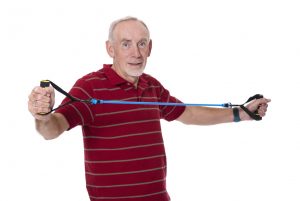Old man exercising with resistance band