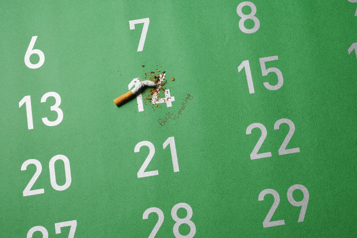 Cigarette stubbed out on green big calendar Evidently Cochrane