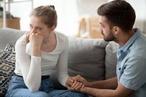 Caring husband hold wife hand making peace after fight